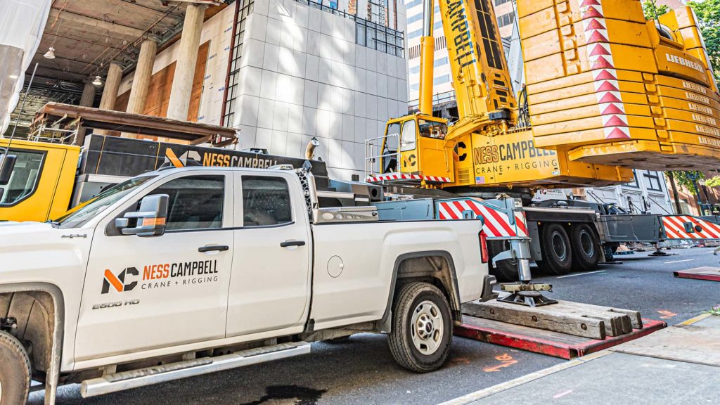 Pick up truck and a crane on the street | Crane Rental Services | NessCampbell