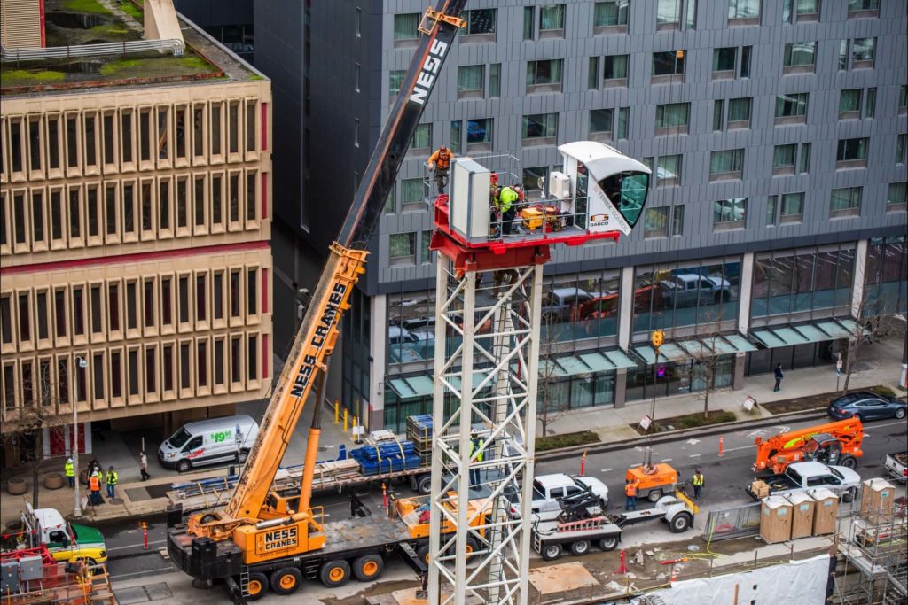 A crane operating on a city building | Crane Rental Services | NessCampbell