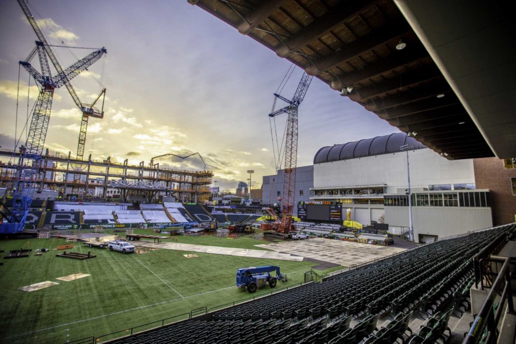 Stadium under construction with cranes and a field | Crane Rental Services | NessCampbell