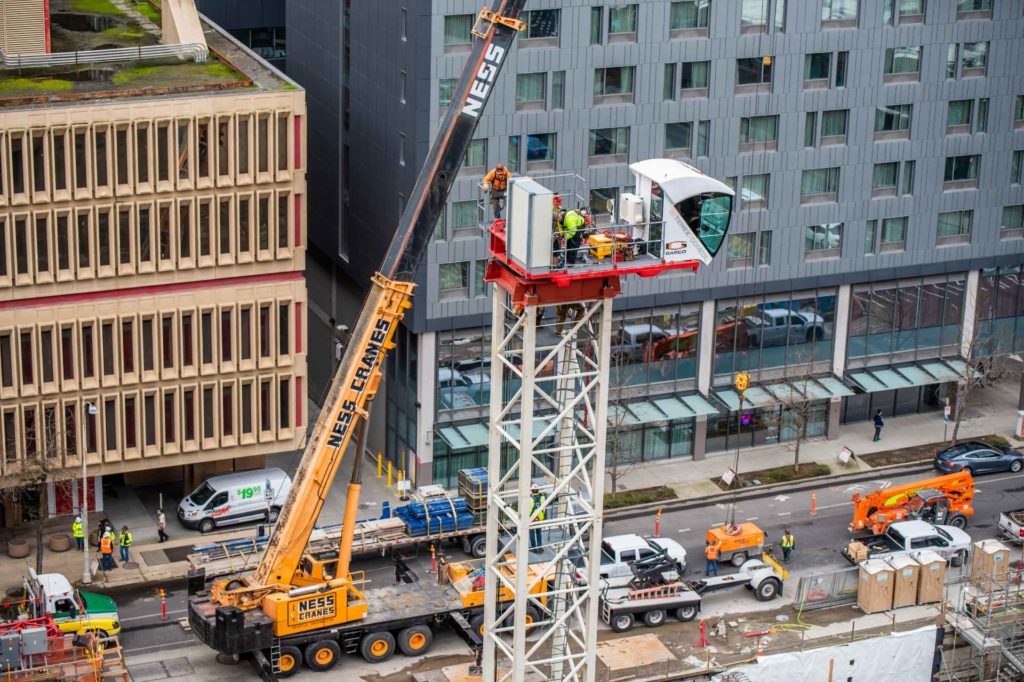 A crane operating on a city building | Crane Lift Planning | NessCampbell