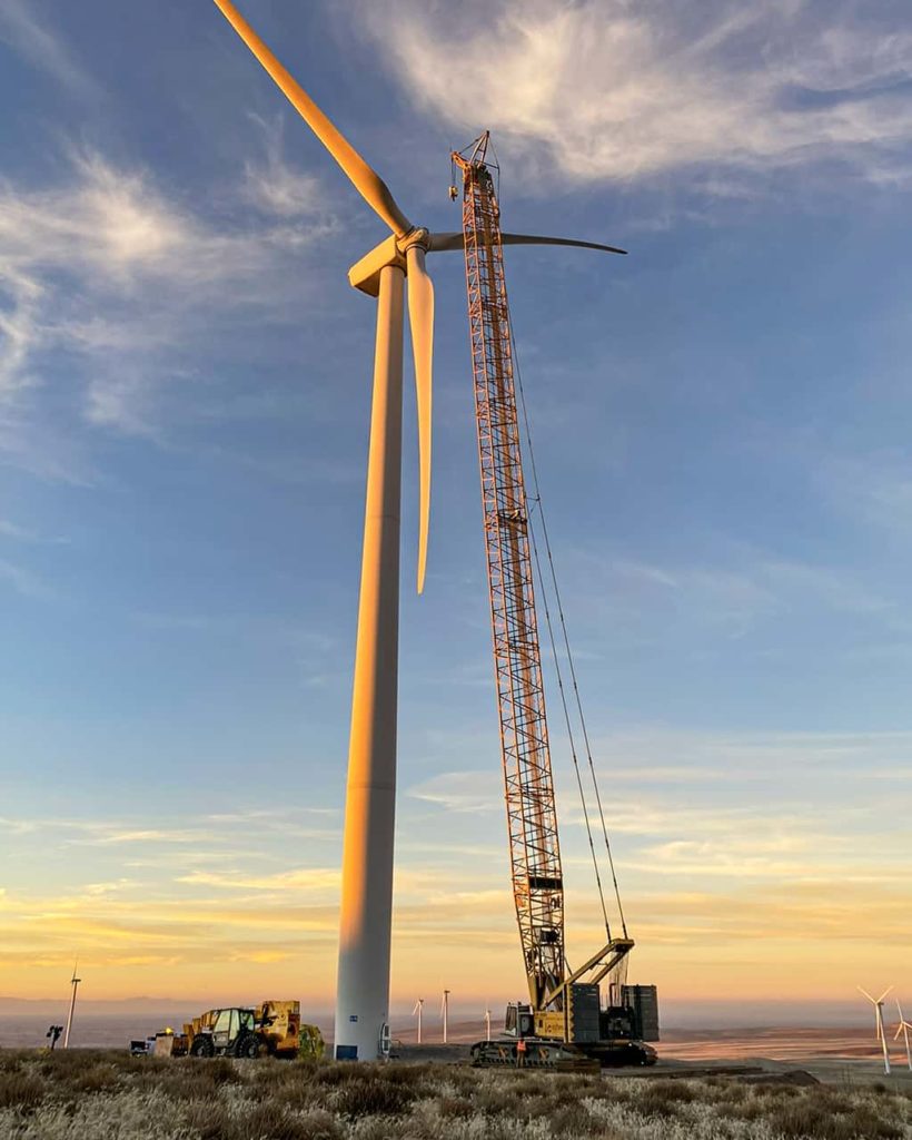Sunset scene with a crane working on a wind turbine | Crane Rental Services | NessCampbell