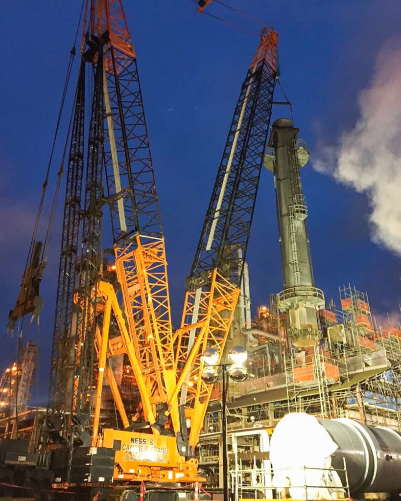 A night scene shows a massive crane hoisting a large pipe | Crane Operation | NessCampbell