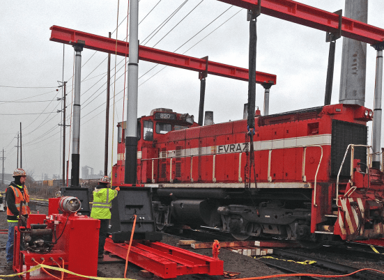 A red train on the tracks with a crane | Crane Operator | NessCampbell
